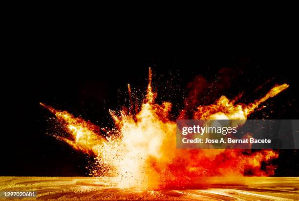 explosion on impact with the ground with fire, smoke and sparks on a black background - bomb explosion fotografías e imágenes de stock