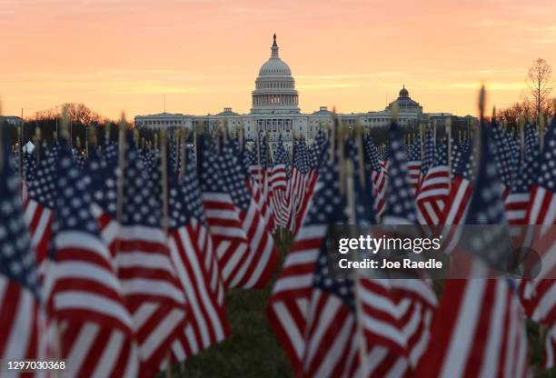 The U.S Capitol Building is prepared for the inaugural ceremonies for President-elect Joe Biden as American flags are placed in the ground on the...