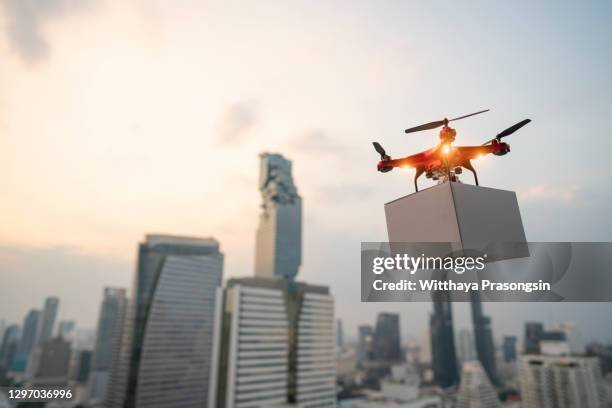 drones carry express packages in city - drone foto e immagini stock