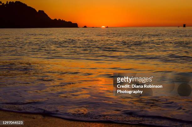 sunset and reflection on water surface on the pacific ocean at baker beach, san francisco, california - baker beach stock pictures, royalty-free photos & images
