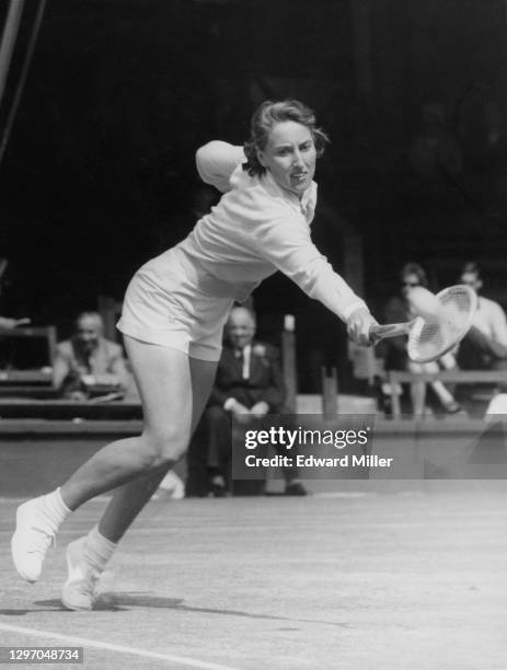 Angela Mortimer of Great Britain reaches to make a back hand to Vera Sukova of Czechoslovakia during their Women's Singles Quarter Final match on...