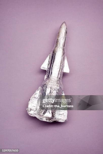 still life of a self made rocket on purple background - model rocket stock pictures, royalty-free photos & images