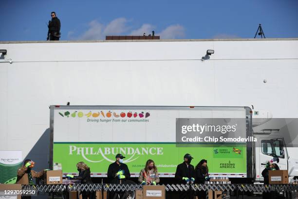 As a U.S. Secret Service agent watches from the rooftop, Dr. Jill Biden, Peter Neal, Finnegan Biden, U.S. President-elect Joe Biden and Ashley Biden...