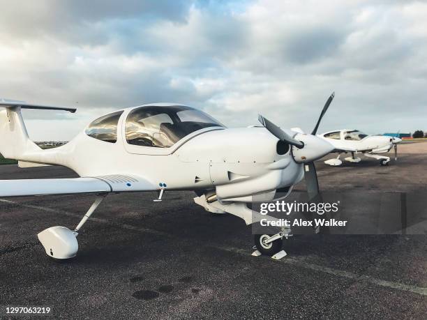 two parked single engine propeller aircraft - small jet stock pictures, royalty-free photos & images