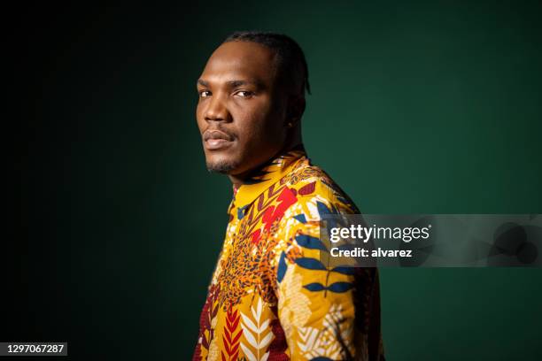 portrait of a confident young african man - man in black shirt stock pictures, royalty-free photos & images