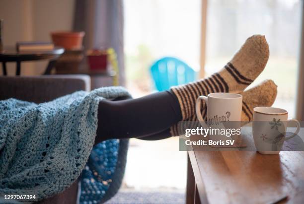 young woman with legs in wool socks - hot drink stock pictures, royalty-free photos & images