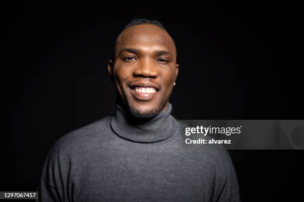 confident african man on black background - male model facial expression stock pictures, royalty-free photos & images