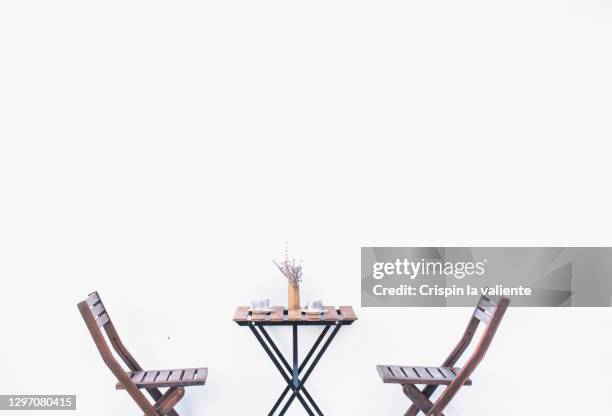 wooden table of a terrace and chairs of a bar with white background - sidewalk cafe stock pictures, royalty-free photos & images