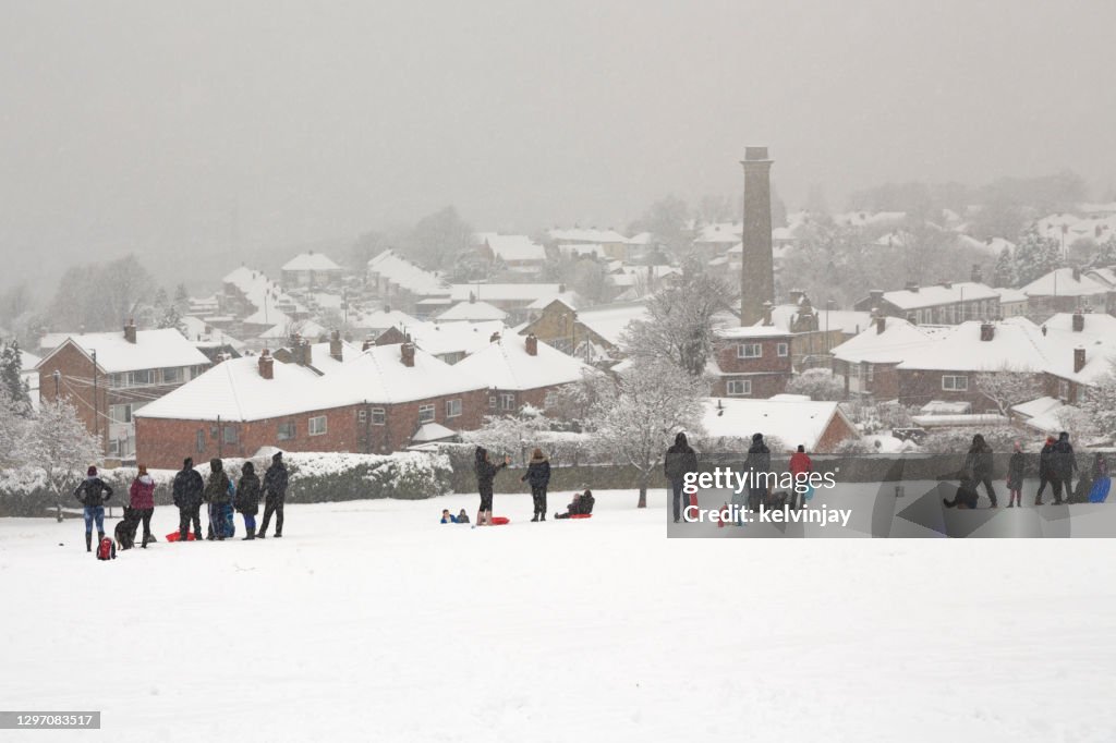 People enjoying a snow day in the local park