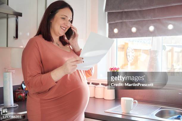 pregnant lady on the phone - debt free stock pictures, royalty-free photos & images