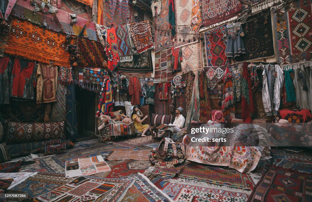 Young tourists enjoying at traditional carpet shop in Cappadocia, Turkey