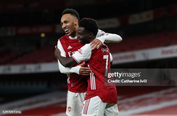 Bukayo Saka of Arsenal celebrates with teammate Pierre-Emerick Aubameyang after scoring their team's second goal during the Premier League match...