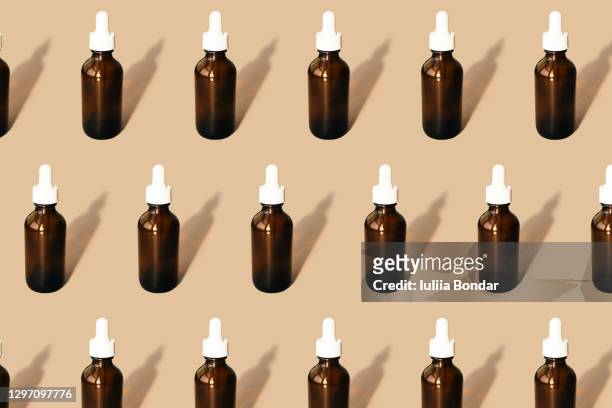 pattern of their transparent bottles with cosmetic. - serum sample stock pictures, royalty-free photos & images