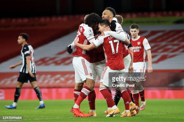 Pierre-Emerick Aubameyang of Arsenal celebrates with teammates Alexandre Lacazette, Mohamed Elneny and Cedric Soares after scoring their team's third...