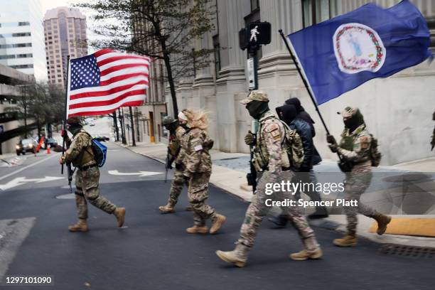 Members of a militia join other gun rights advocates in front of the State House as pro-gun supporters gather on January 18, 2021 in Richmond,...