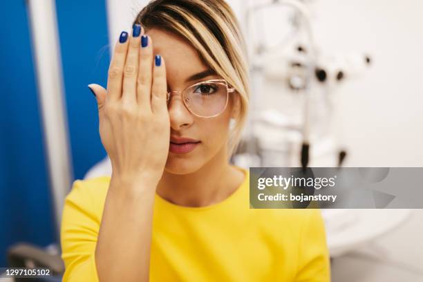 beautiful young woman at ophthalmologist - phoroptor stock pictures, royalty-free photos & images