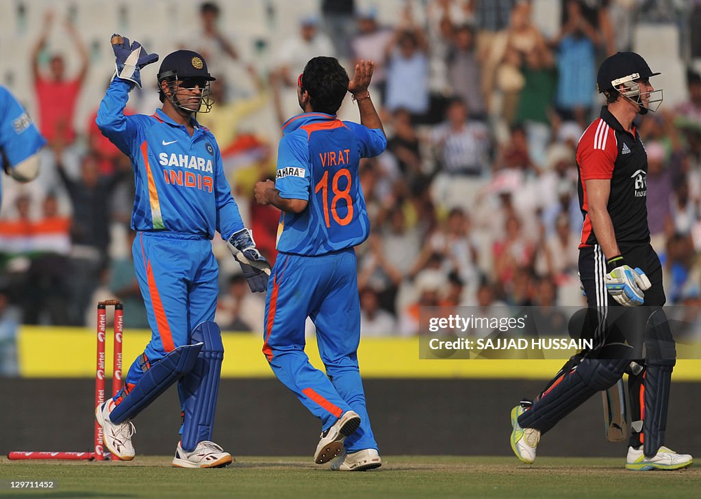 Indian bowler Virat Kohli (C) celebrates