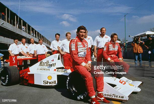 Brazilian racing driver Ayrton Senna and his Austrian teammate Gerhard Berger pose with the rest of the McLaren team at the Mexican Grand Prix at the...