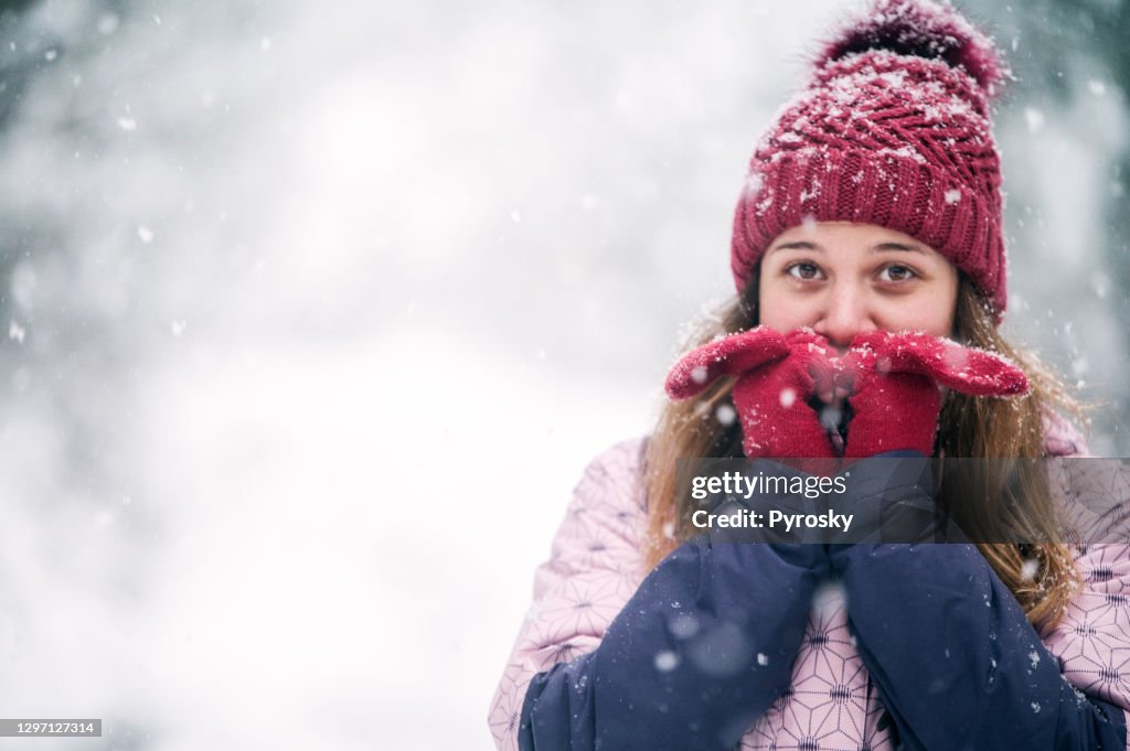 Smiling woman heating up her hands