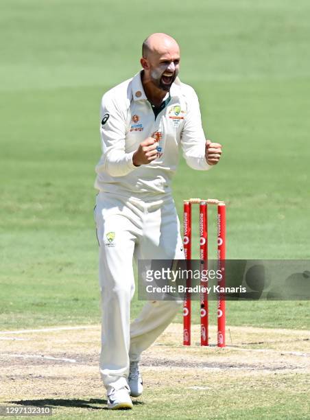 Nathan Lyon of Australia celebrates taking the wicket of Shubman Gill of India during day five of the 4th Test Match in the series between Australia...