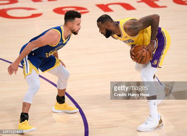 LeBron James of the Los Angeles Lakers is guarded by Stephen Curry of the Golden State Warriors during the first half at Staples Center on January...