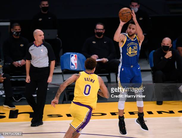 Stephen Curry of the Golden State Warriors shoots a three pointer in front of Kyle Kuzma of the Los Angeles Lakers during a 115-113 Warriors win on...
