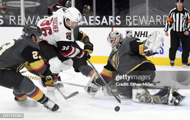 Robin Lehner of the Vegas Golden Knights makes a save against Christian Fischer of the Arizona Coyotes as Alec Martinez of the Golden Knights defends...