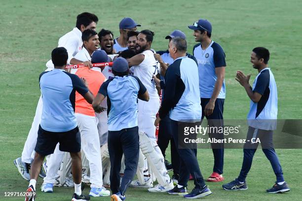 Indian players celebrate after their victory during day five of the 4th Test Match in the series between Australia and India at The Gabba on January...
