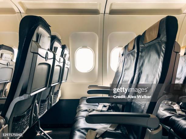 empty seats in a commercial aircraft - window seat stockfoto's en -beelden