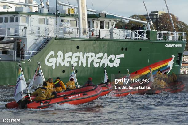 The Rainbow Warrior III, the newest ship of the enivornmental conservation organization Greenpeace,is accompanied by Greenpeave activists in rubber...