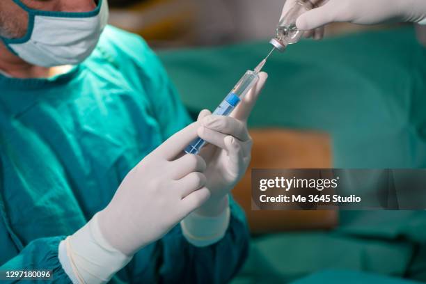 doctors in the operating room are injections of the back of the patient's mother. - surgical scissors stock pictures, royalty-free photos & images