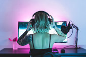 Female gamer putting her headphones on