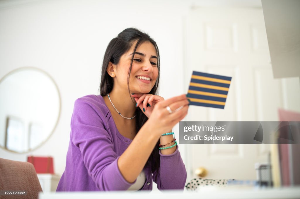 Young Woman Reading a Letter at Her Desk