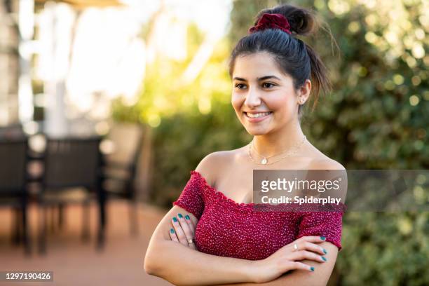 young armenian woman standing in backyard with arms crossed - beautiful armenian women stock pictures, royalty-free photos & images