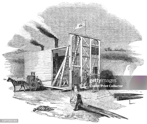 Patent American steam pile-driving engine, 1844. Workers operating 'Cram's Patent Steam Pile Driver', a machine used in the construction of railways...