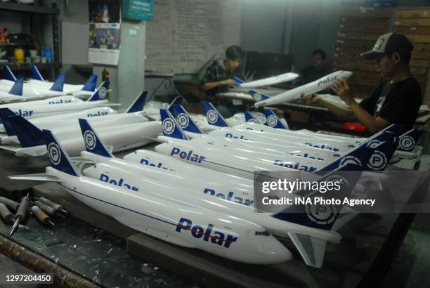 An employee works on aircraft miniatures at the Anglo Aircraft Model workshop in Cibinong, Bogor Regency, West Java, Indonesia, on November 24, 2020....