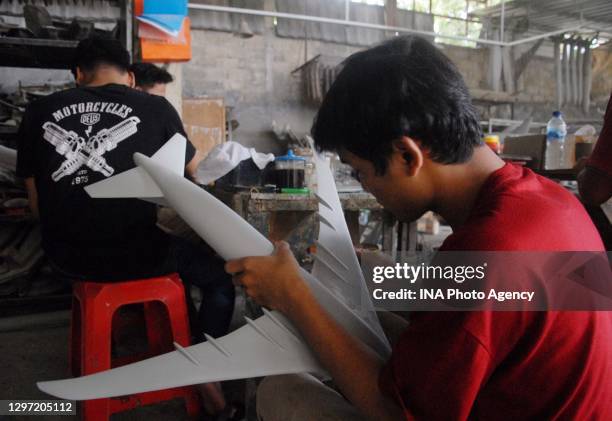 An employee works on aircraft miniatures at the Anglo Aircraft Model workshop in Cibinong, Bogor Regency, West Java, Indonesia, on November 24, 2020....