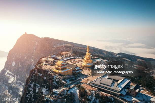 drone photo of golden statue at mt emei gold summit - emei shan stock pictures, royalty-free photos & images