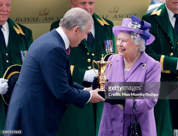Prince Andrew, Duke of York presents his mother Queen Elizabeth II with the Ascot Gold Cup after her horse 'Estimate' won the feature race on day 3...
