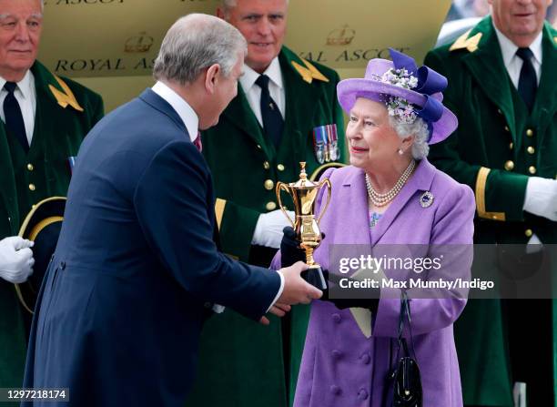 Prince Andrew, Duke of York presents his mother Queen Elizabeth II with the Ascot Gold Cup after her horse 'Estimate' won the feature race on day 3...