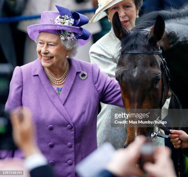 Queen Elizabeth II pats her horse 'Estimate' after it won the Ascot Gold Cup on day 3 'Ladies Day' of Royal Ascot at Ascot Racecourse on June 20,...