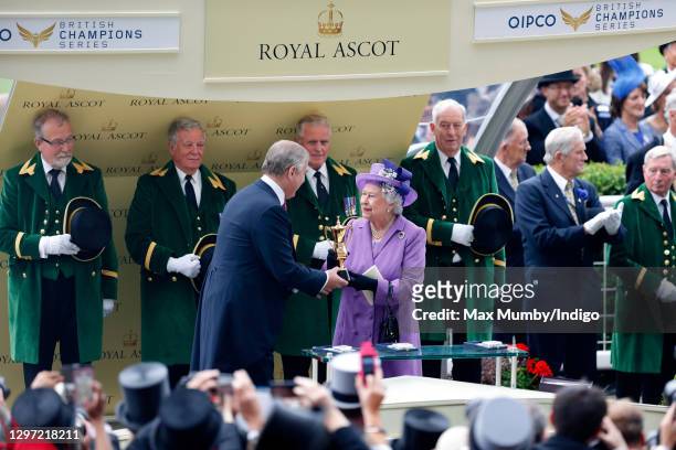 Prince Andrew, Duke of York presents his mother Queen Elizabeth II with the Ascot Gold Cup after her horse 'Estimate' won the feature race on day 3...
