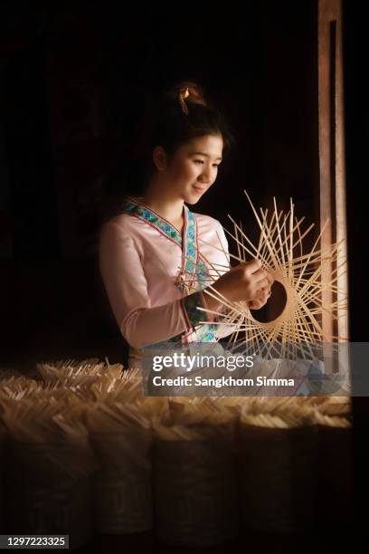 beautiful girl making a basket with bamboo. - making a basket imagens e fotografias de stock