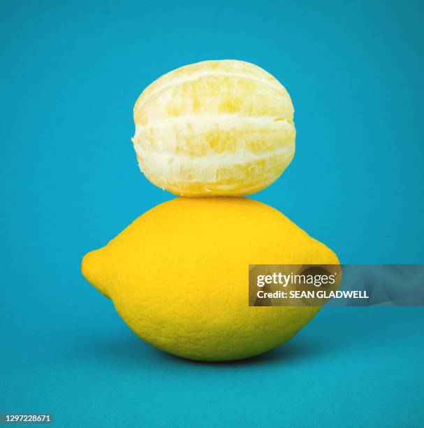 lemons on blue background - lemon peel foto e immagini stock