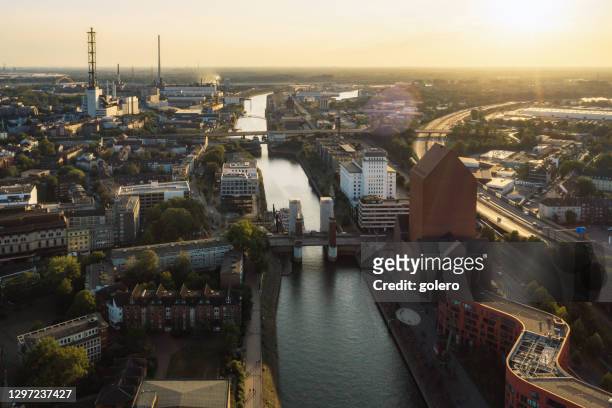drone view over canal in old harbor of duisburg at sunset - duisburg stock pictures, royalty-free photos & images