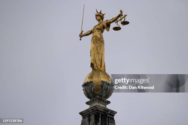 Statue of the Scales of Justice stands above the Old Bailey on January 19, 2021 in London, England. Criminal watchdogs representing England and Wales...