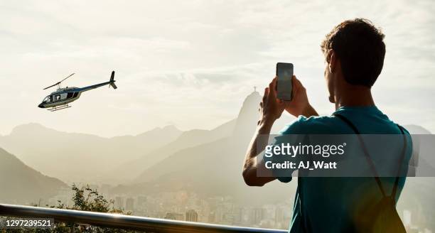young traveler taking photos - helicopter photos imagens e fotografias de stock