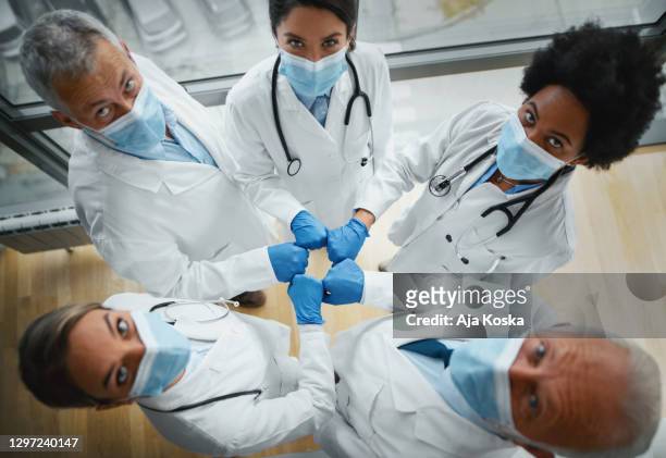 doctors united against pandemic. - surgical glove stock pictures, royalty-free photos & images