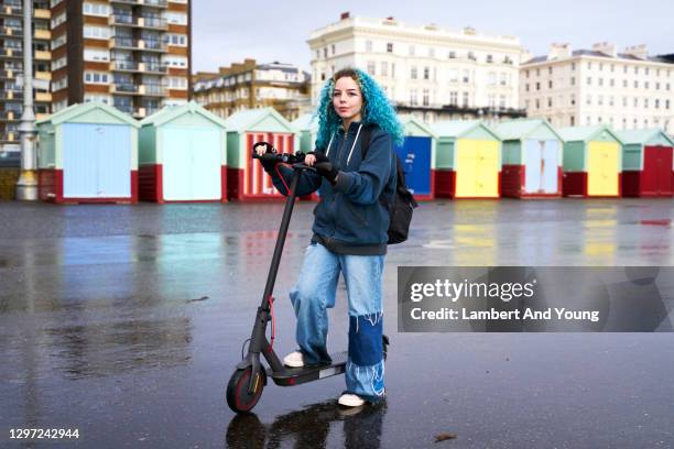 young woman posing at the beach with her electric scooter - girls scooters bildbanksfoton och bilder
