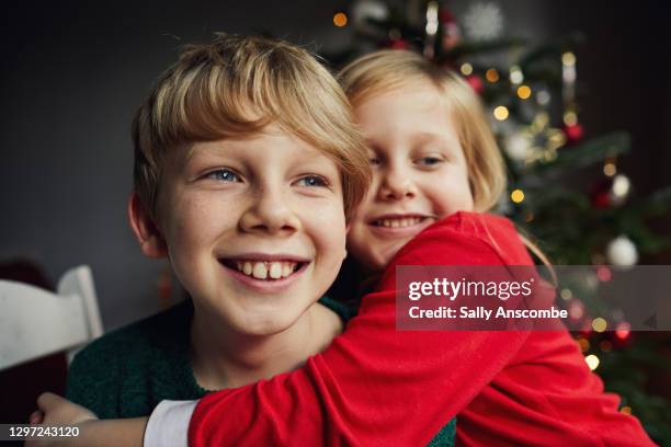 two happy smiling children - sibling christmas stock pictures, royalty-free photos & images